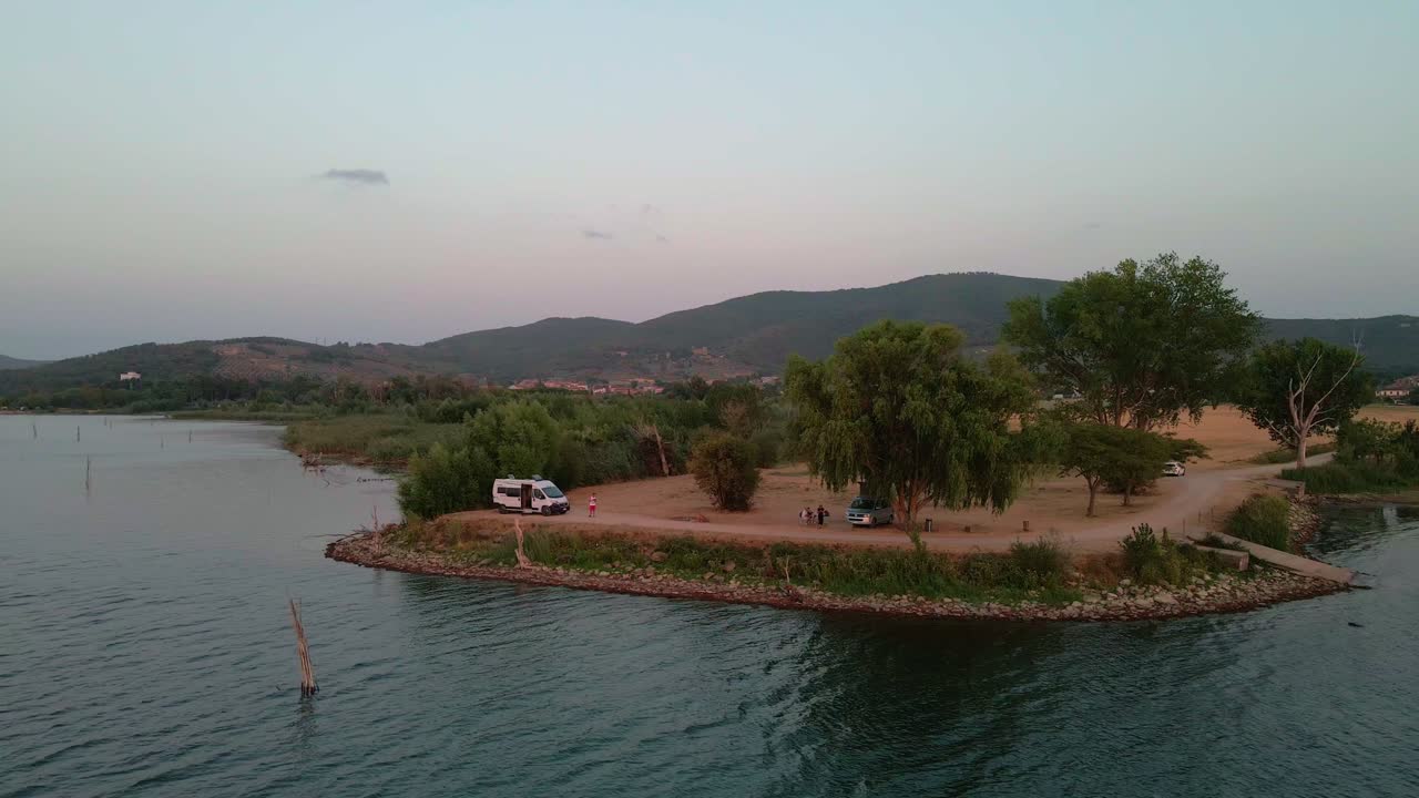 Aerial View On Trasimeno Lake With Tourists Enjoying The Idyllic Scenery At Sunset - drone shot