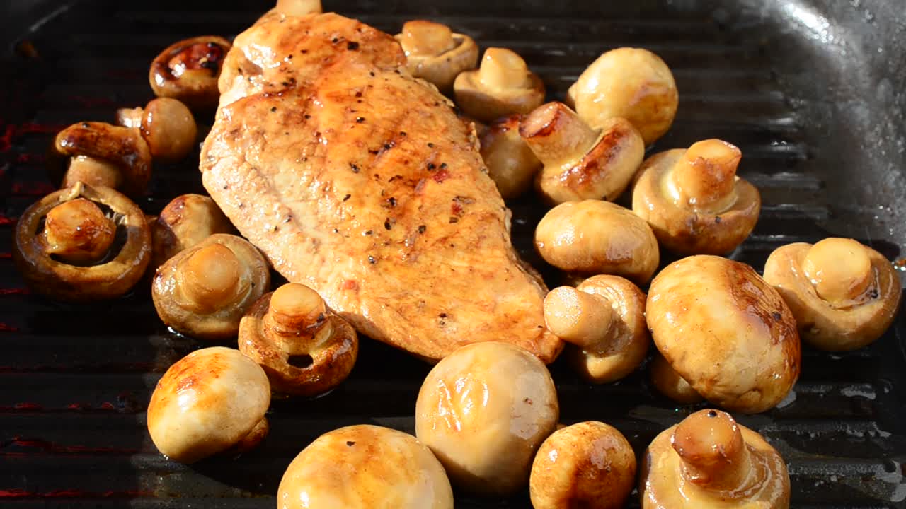 We fry mushrooms with chicken on a grill. We cook a dish