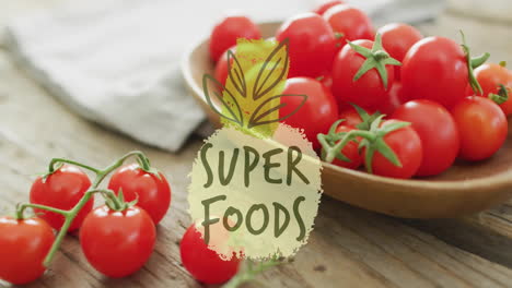 super foods text animation over fresh tomatoes on wooden table