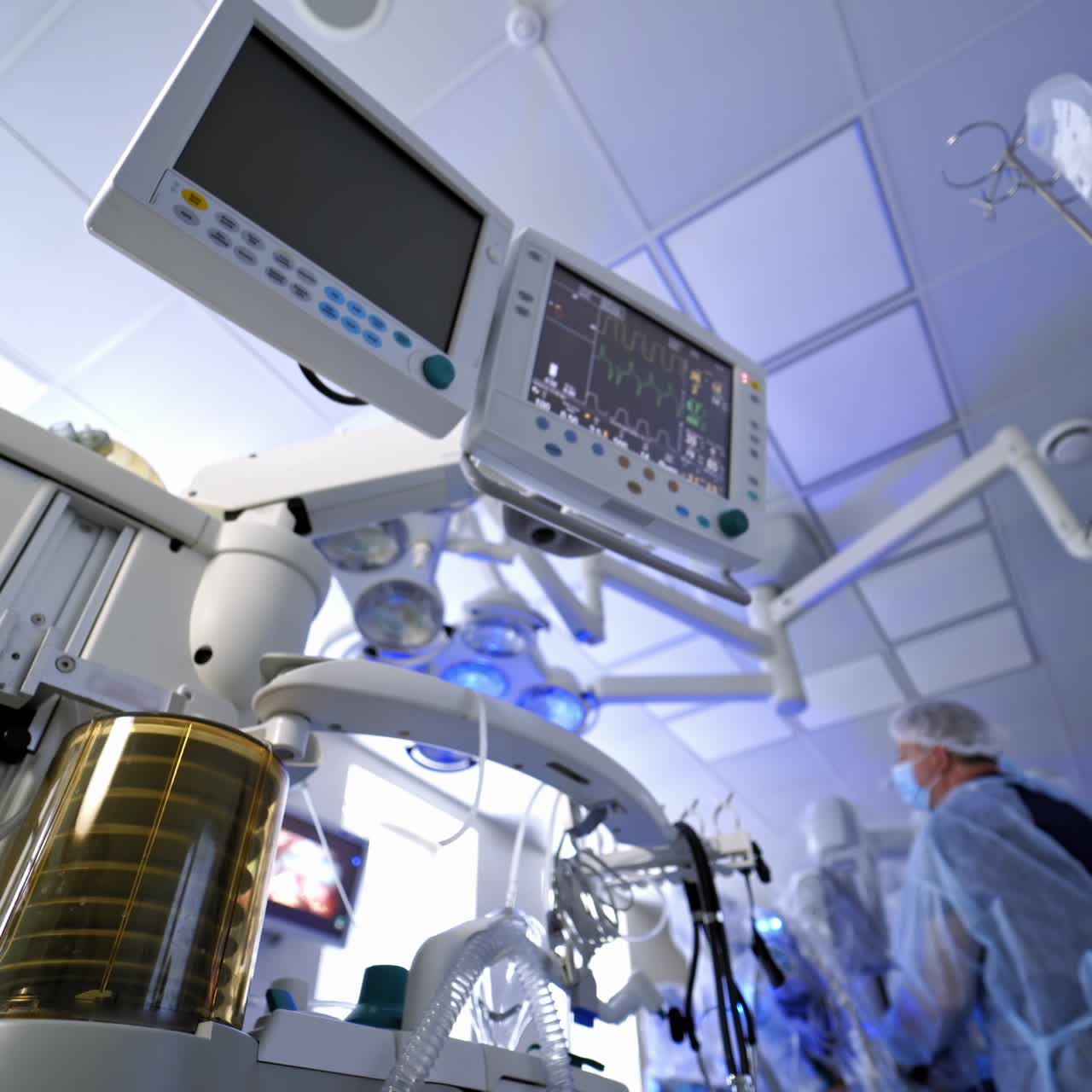 Medical equipment for saving patient's life. Work of artificial lung ventilation device under medical monitors in the operating room. View from below.