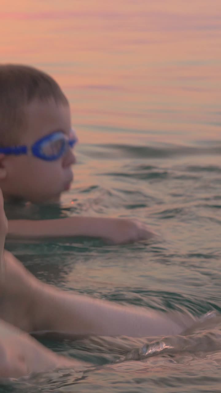 Mother and Child Swimming at Sunset