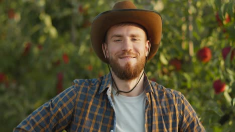 smiling farmer in apple orchard