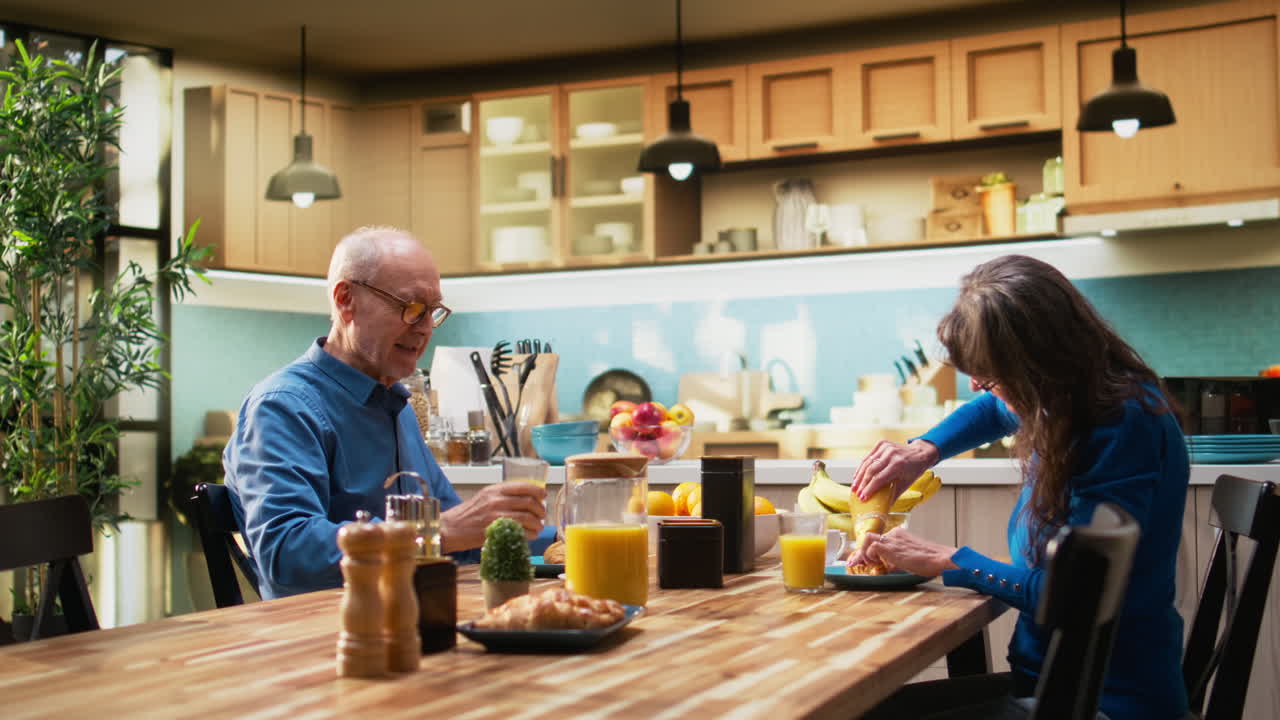 Elderly couple enjoys natural morning routine with healthy homemade breakfast