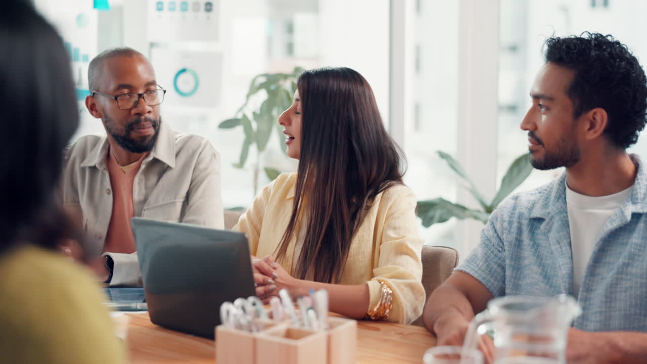 Diverse Team Celebrates Success with a Handshake at Business Meeting