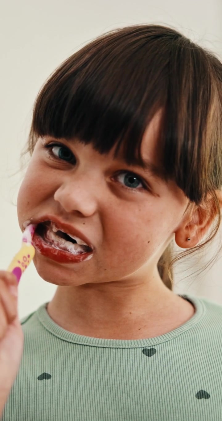 Young Girl Brushing Her Teeth in the Morning