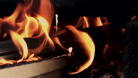 slow motion closeup on the fire of indian traditional style hand made fire place to cook the food with wood - coal etc