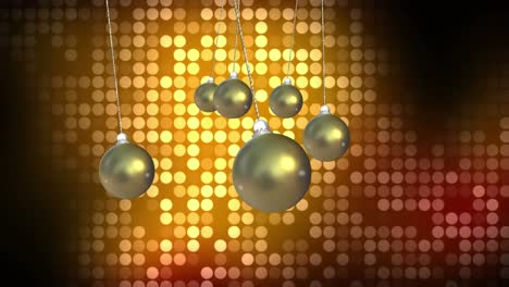 Animation-of-christmas-baubles-dangling-over-flickering-yellow-spots-in-background