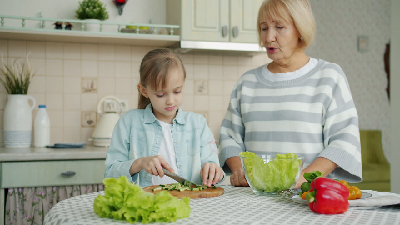 Granddaughter Helping Grandma Prepare a Salad