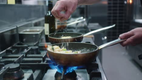 spreading cheese on a pasta dish