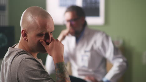 doctor discussing diagnosis with bald patient