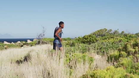 african american man cross country running in countryside on a mountain