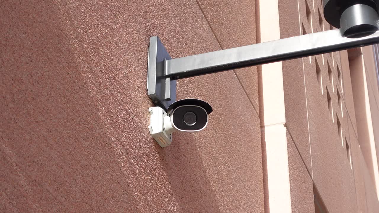 Security camera mounted on a building wall