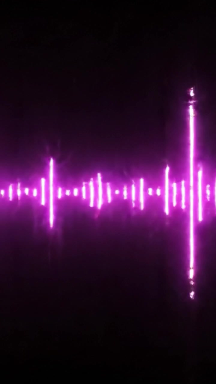 A Dynamic Visual Representation of Sound Waves with Neon Light Effects Transitioning from Blue to Pink in a Stunning Display of Pulsating Energy