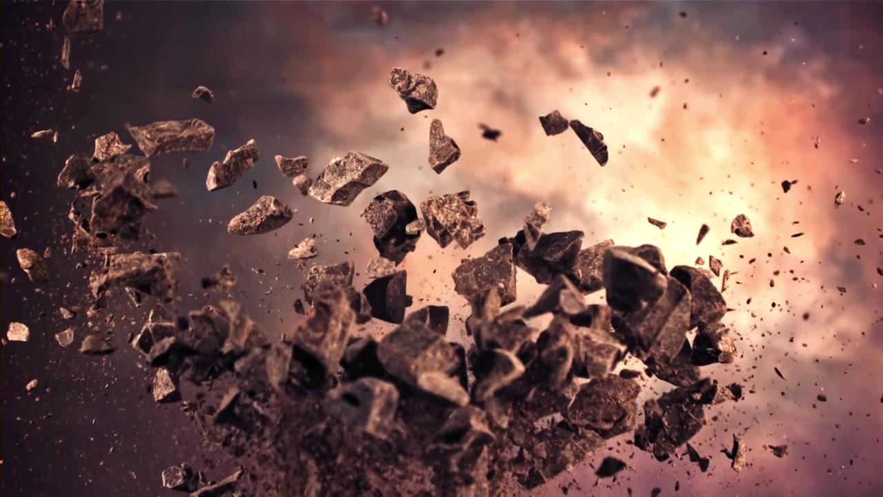 Slow Motion Explosion of Chocolate Chunks Against Dramatic Sky