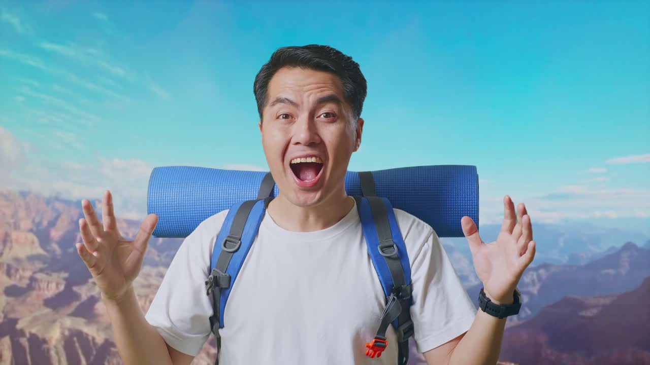 Close Up Of Asian Male Hiker With Mountaineering Backpack Saying Wow While Traveling At The Top Of Mountain