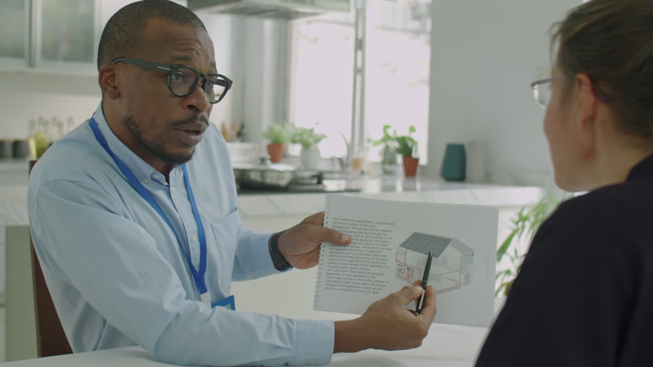 Black Engineer Explaining Solar Power Project to Colleague