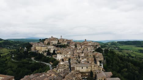 drone shot pulling away from montepulciano, tuscany in italy's countryside