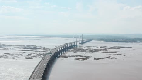 dolly forward aerial drone shot towards prince of wales bridge over severn estuary