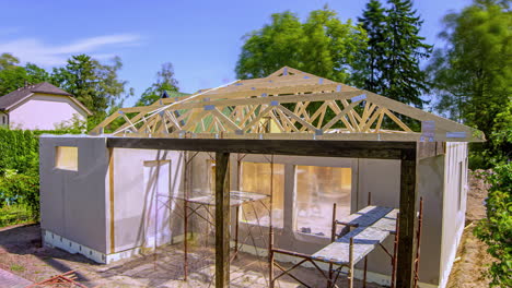 timelapse of workers building a wooden roof structure on a private home, summer day