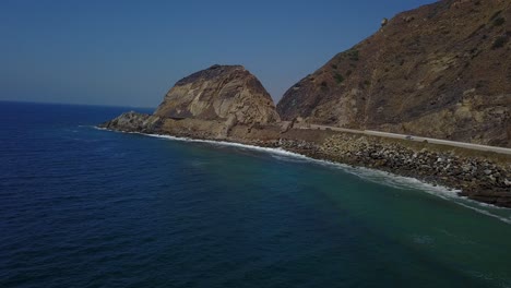 an overview sliding shot of point mugu rock - pacific coast highway.