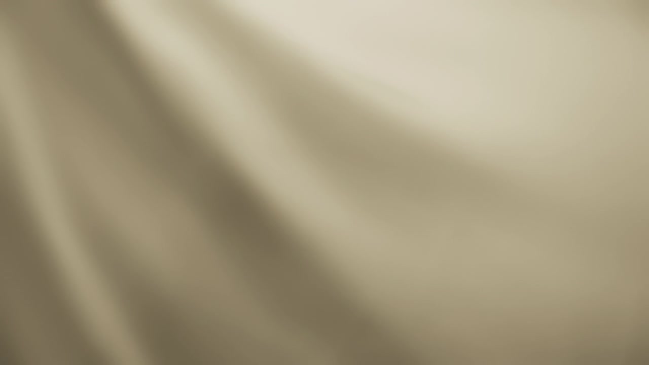 Abstract background of creamy beige chiffon waving in the wind