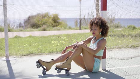 young fit woman posing in roller skates