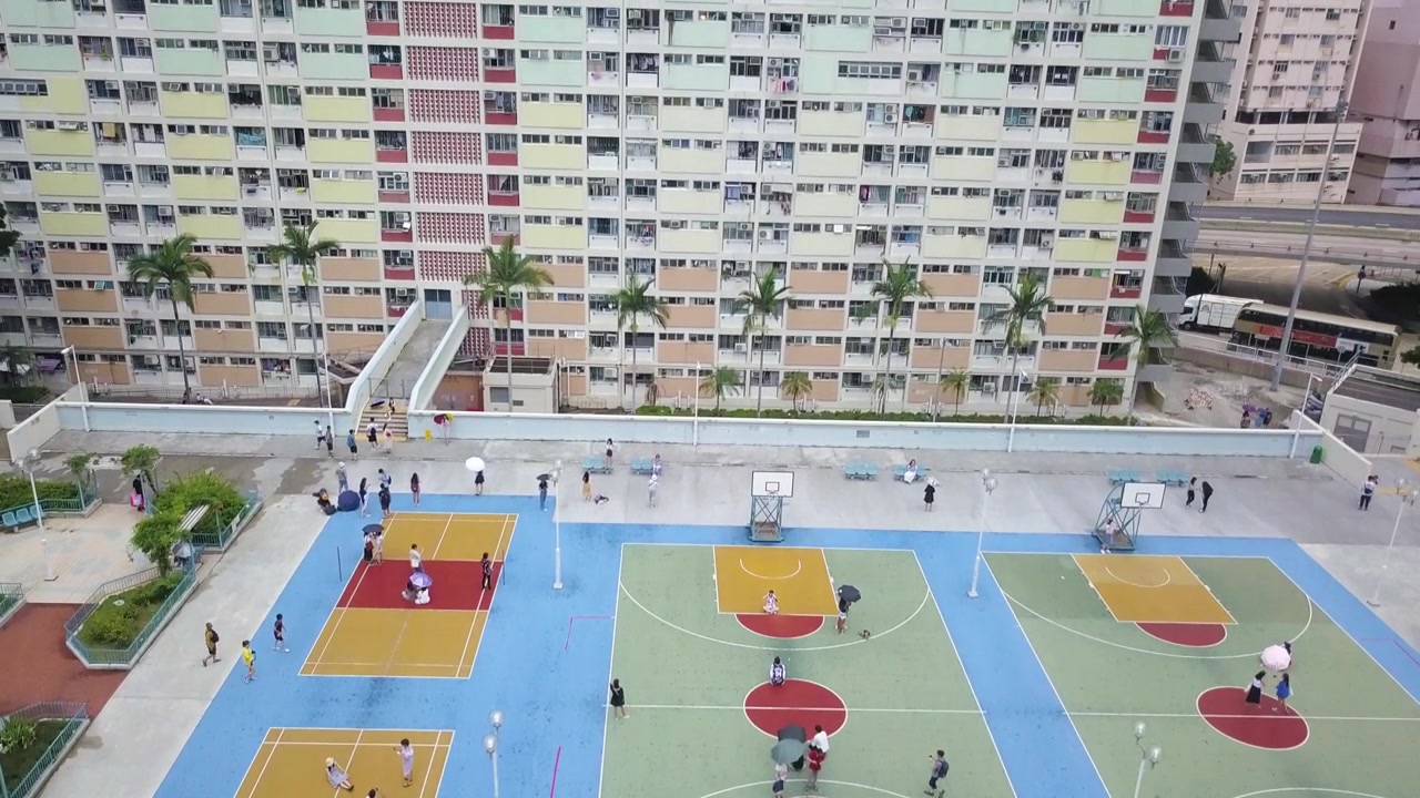 Vista aerea dall'alto della Choi Hung Estate a Hong Kong, con giovani che scattano fotografie e immagini perfette per Instagram.