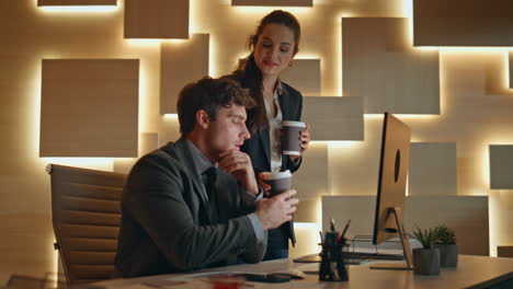 business colleagues discussing project in office at night