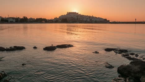 timelapse of surnise behind peñíscola castle ending with stunning star shaped sunbeams