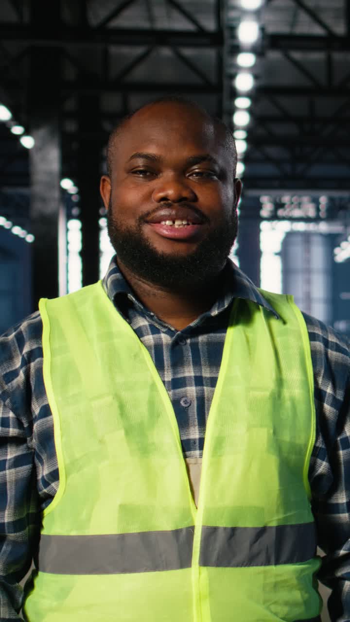 Vertical Video Portrait of african american technician wearing workshop equipment