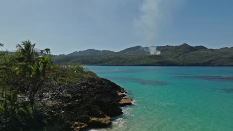 Drone-flying-at-low-altitude-over-cliffs-of-Playa-Rincon,-Las-Galeras-in-Dominican-Republic