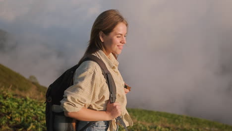 woman hiking in the mountains at sunrise/sunset