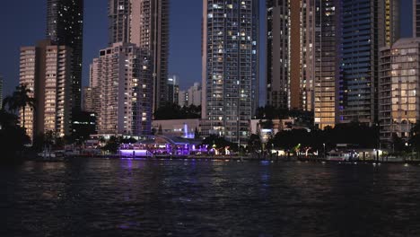 nighttime view of illuminated city skyline and river