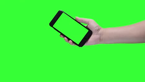 hand holding smartphone on green screen background