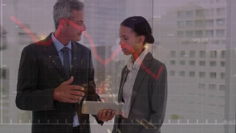 Animation-of-red-graph-moving-over-diverse-businessman-and-businesswoman-discussing-at-office