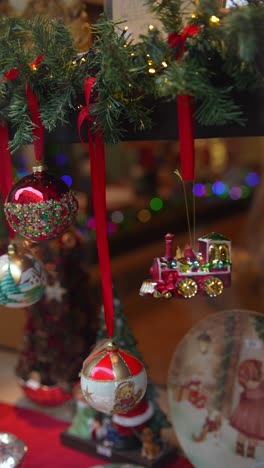 christmas window display with ornaments and train