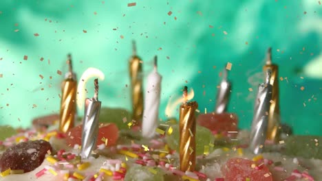 Animation-of-confetti-falling-over-candles-on-birthday-cake