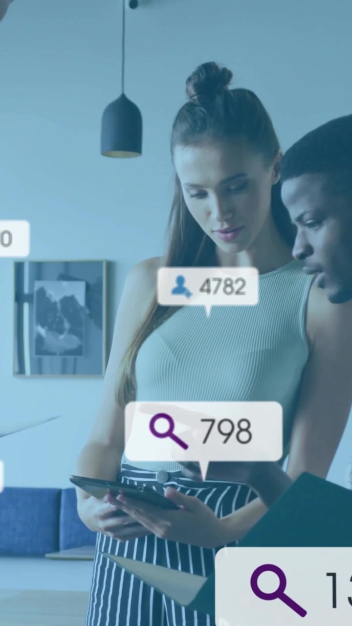 Vertical video: Colleagues scrolling tablet and generating floating follower counts for marketing