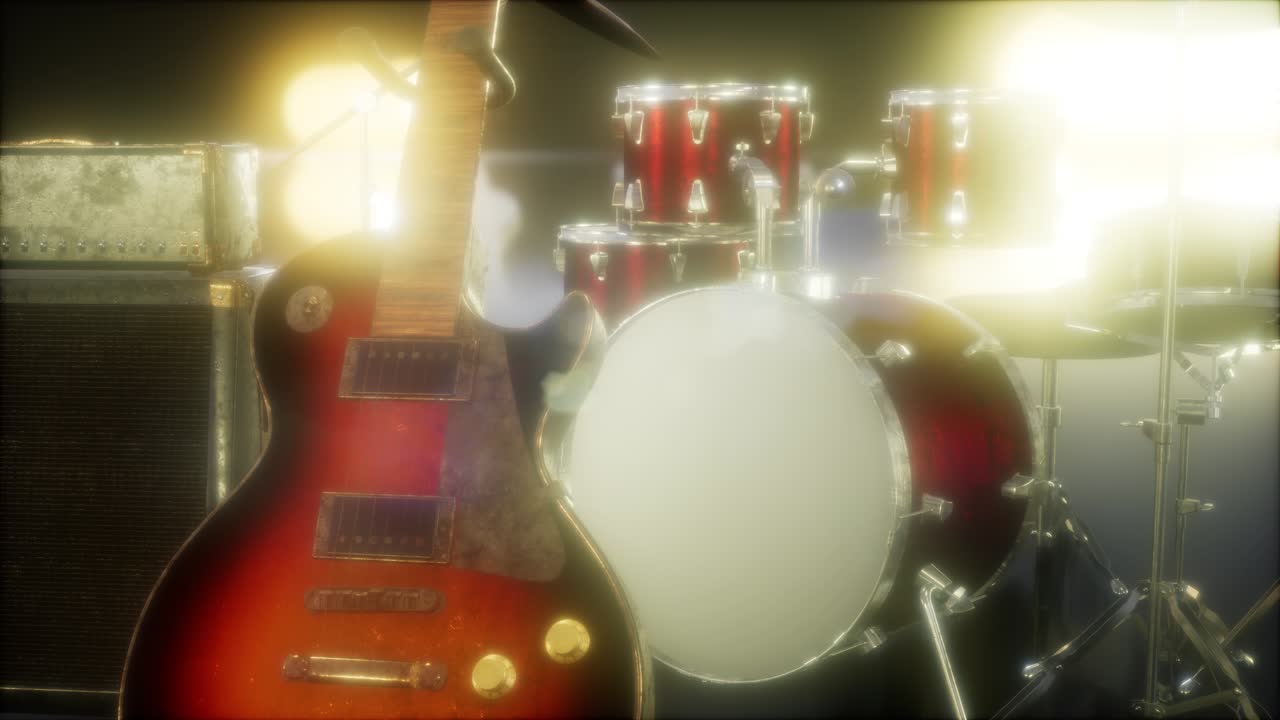 batteria e chitarra in un'illuminazione sottile del palco.