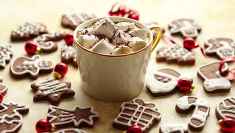 cup of hot chocolate and christmas shaped gingerbread cookies