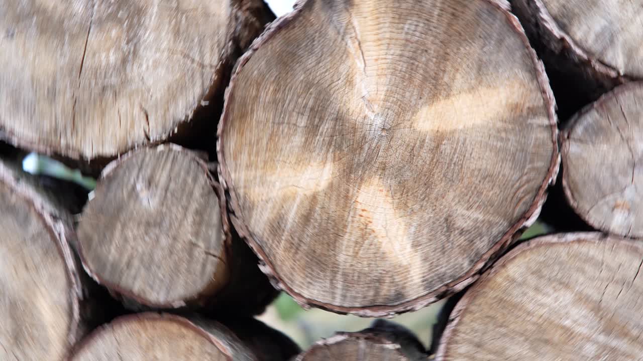 Stacks of lumber together. Wood storage. Firewood cut tree trunk logs stacked prepared. Circular motion of the camera