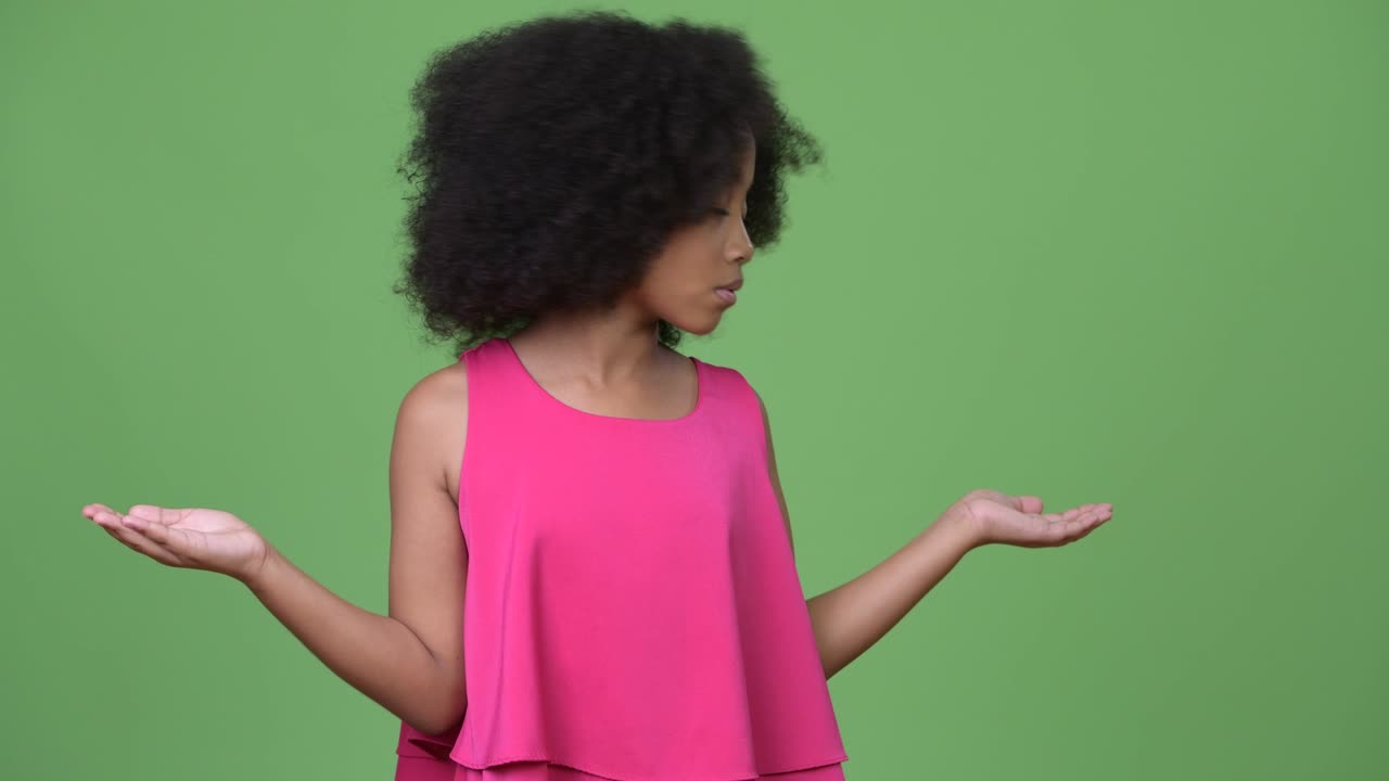Young cute African girl with Afro hair choosing between left and right