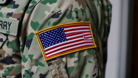 american flag patch on military camouflage uniform