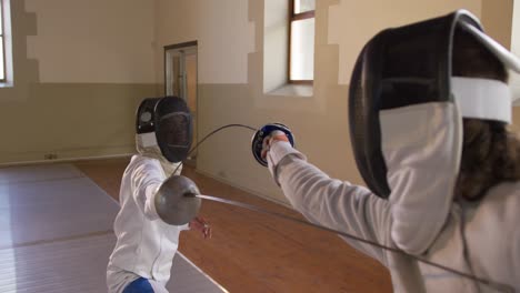 fencer athletes during a fencing training in a gym