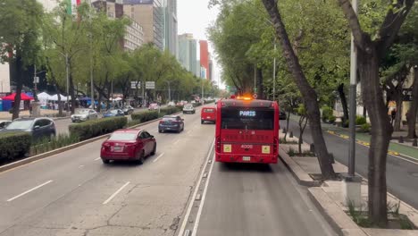 mexico city street scene with red bus