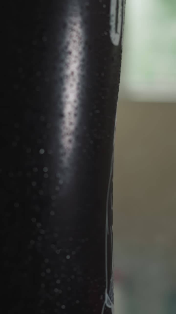 el entrenador de boxeo en guantes entrega un golpe poderoso a la bolsa de boxes en el gimnasio con equipos. el especialista en hombres participa activamente en deportes y construye masa muscular