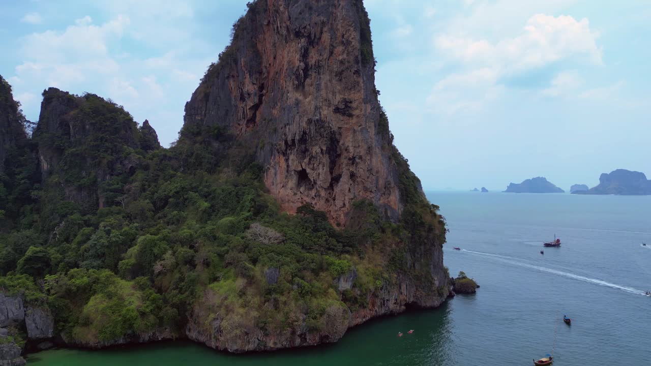 pensioner resting during a difficult Rock climb on Rai Leh beach cliff in Thailand. Great aerial view flight speed ramp hyper motion time lapse
