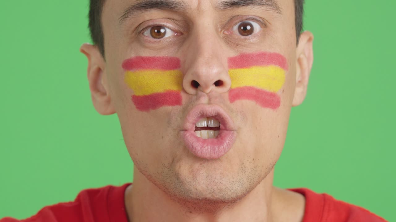 Close up of a man supporting spanish team