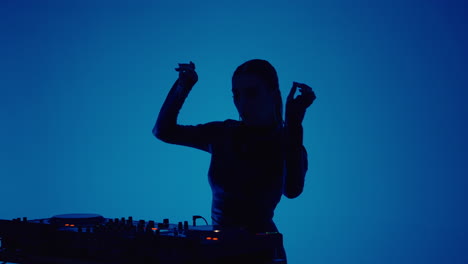 female dj mixing music in a studio