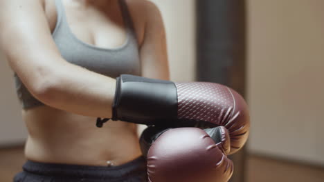 Close-up-shot-of-female-boxers-hands-in-boxing-gloves